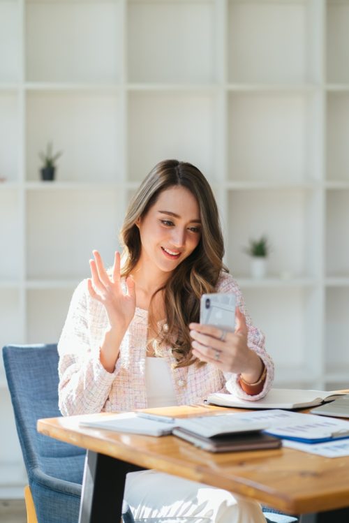 Young,Business,Asian,Woman,Sit,On,Wooden,Table,At,Home